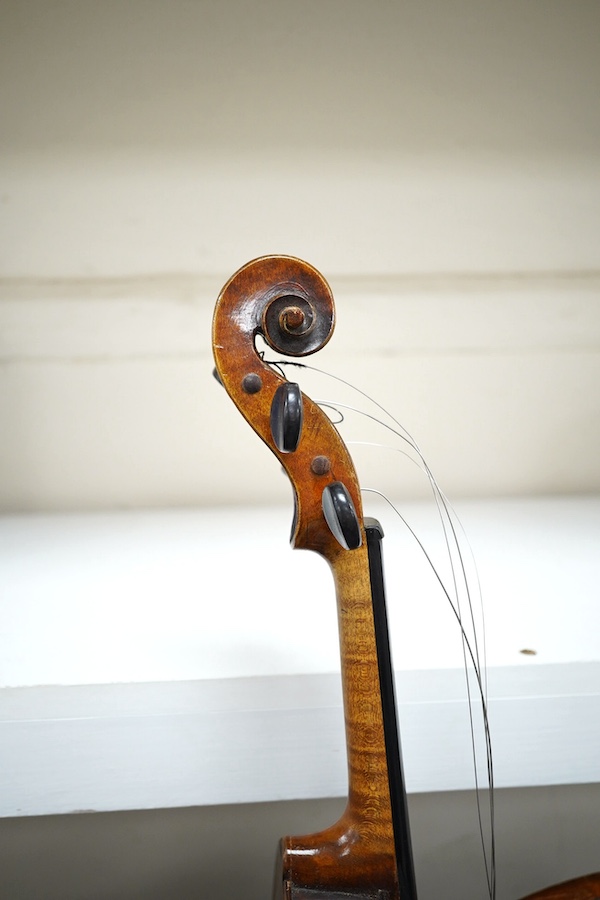 A cased violin, possibly German, body 35.5cm, in a good wooden case with canvas outer cover. Condition - fair